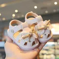 Sweet pink infant summer sandals featuring a lace bow and hollowed heart patterns. - Pink