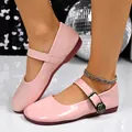 Detailed view of pink patent leather Mary Jane flats featuring a floral metal buckle - 36 / Pink