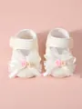 Macro view of cream lace baby princess pre-walker shoes featuring a large decorative bow - Beige