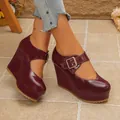 Close-up detail of stylish burgundy patent leather platform wedge Mary Jane shoes - Burgundy