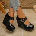 Close-up of black patent leather wedge Mary Jane shoes with square toe and platform - Black