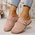 Close-up of pink platform slippers with floral perforations and gold buckle decoration. - Lotus Pink