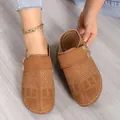 Stylish women's brown laser-cut closed-toe clogs featuring decorative buckle and white stitching - 36 / Tan