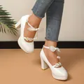 Elegant white block heel Mary Jane shoes featuring floral straps and pearl bow accents. - 35 / White
