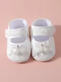 Close-up of elegant white lace baby princess shoes with faux pearl and satin bow details - Size 11 (Inner Length 10.5cm) / White