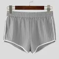 Macro view of grey ribbed athletic shorts with elastic waist and white piping detail - S / Bottom (L8014) / Gray