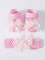 Detailed close-up of pink baby lace shoes and matching floral headband set for infants. - 11 (10.5cm) / Shoe and Headband Set / Pink