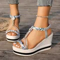 Side view of silver wedge sandals with braided straps on wooden deck - 36 / Silver