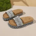 Detailed view of women's platform sandals with elegant pearl and rhinestone straps. - 35 / Black