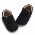 Top view of black baby walking shoes with brown trim and soft soles for infants. - Inner Length 11cm / Black