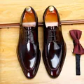 Elegant burgundy patent leather men's dress shoes displayed with a matching silk bow tie - 37 / Burgundy