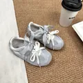 Detailed top view of grey mesh girls' sneakers with decorative plaid ribbons on a rug - 27 / Gray