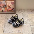 Detail view of children's closed-toe athletic sandals on stone floor. - Size 17 Insole 13.5cm / Yellow
