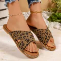 Close-up of leopard print criss-cross flat sandals with gold stud details on soles. - 36 / Brown Leopard Print