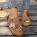 Close-up detail of retro brown platform clogs with cute cartoon dog and cookie charms - 36 / Brown