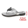 Close-up detail of silver women's thong sandal showing the 2.7cm flat heel height measurement - Silver