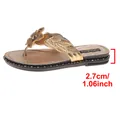 Close-up detail of golden women flip-flops showing the 2.7cm platform heel height - Gold