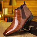 Detailed macro view of men's brown Chelsea boots featuring premium crocodile skin texture - 39 / Dark Brown