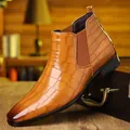 Detailed side view of tan crocodile-patterned Chelsea boot on vintage wooden trunk. - 39 / Tan