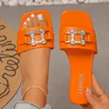Vibrant orange flat slides with square toe and rhinestone buckle detail for women - Orange