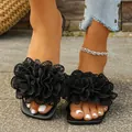 Chic black flat slide sandals featuring oversized lace flower decorations for summer - Black