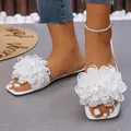 Elegant white flat beach sandals for women featuring large stylish fabric flowers - White