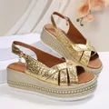 Detailed view of gold platform wedge sandals with crocodile skin texture and rose buckle - Gold-3