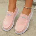 Close-up detail of stylish pink canvas slip-on loafers with frayed edges on feet - 36 / Pink