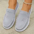 Detail of women's grey canvas slip-on loafers with distressed edges and pearl anklet - 36 / Gray