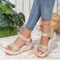Women's beige platform wedge sandals featuring gold textured straps and metal buckle details. - Khaki