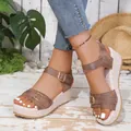 Stylish brown spring-summer wedge sandals featuring buckle straps and textured platform sole - Brown