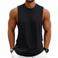 Front view of men's loose black gym tank top with deep armholes on model - S / Tops / Black