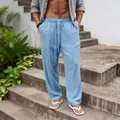 Close-up of breathable light blue linen straight-leg pants for men in loose fit - Light Blue