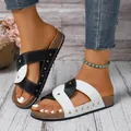 Stylish black and white cross strap sandals with gold rivet accents for a trendy summer look - Black and White