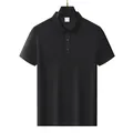Detail view of a classic black short sleeve polo shirt made of breathable fabric on a hanger - M / Tops / Black