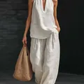 Detail shot of elegant white linen halter V-neck top and matching wide-leg pants - S / Top And Bottom / White