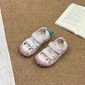 Children's pink closed-toe outdoor sport sandals on a warm neutral textured rug - Pink