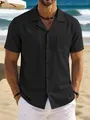 Close-up of a men's black vintage cotton linen short-sleeve shirt on a beach setting. - S / Tops / Black