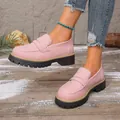 Pink matte platform loafers on model featuring a retro chunky sole design - Pink