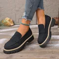 Close-up view of black vintage loafers with thick soles and matte finish on model - 36 / Black