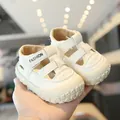 Comfortable white baby walking sandals with closed-toe breathable design and velcro strap. - Beige