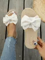 Stylish beige flat slippers featuring a large white bow and comfortable woven texture sole. - 35 / Beige