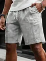Close-up detail of men's black and white vertical striped casual shorts with white drawstring - Black