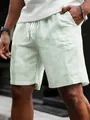 Detailed view of men's green striped casual shorts featuring an adjustable drawstring waist - Green