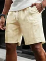 Detail shot of men's yellow vertical striped drawstring shorts with textured fabric - Yellow