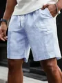 Detailed view of men's blue and white striped drawstring shorts for summer leisure - Blue