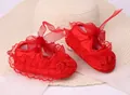 Red soft-sole infant walking shoes featuring delicate lace trim and silk ribbon bows - Red