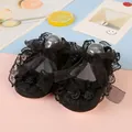 Black lace baby walking shoes featuring elegant ribbon bows and floral accents on a soft sole - Black