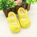 Close-up of yellow floral soft-sole baby shoes with a charming bow knot detail. - Small Flower Yellow