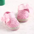 Pink hollow-out crochet baby walking shoes with soft sole and elegant ribbon bow detail - Pink